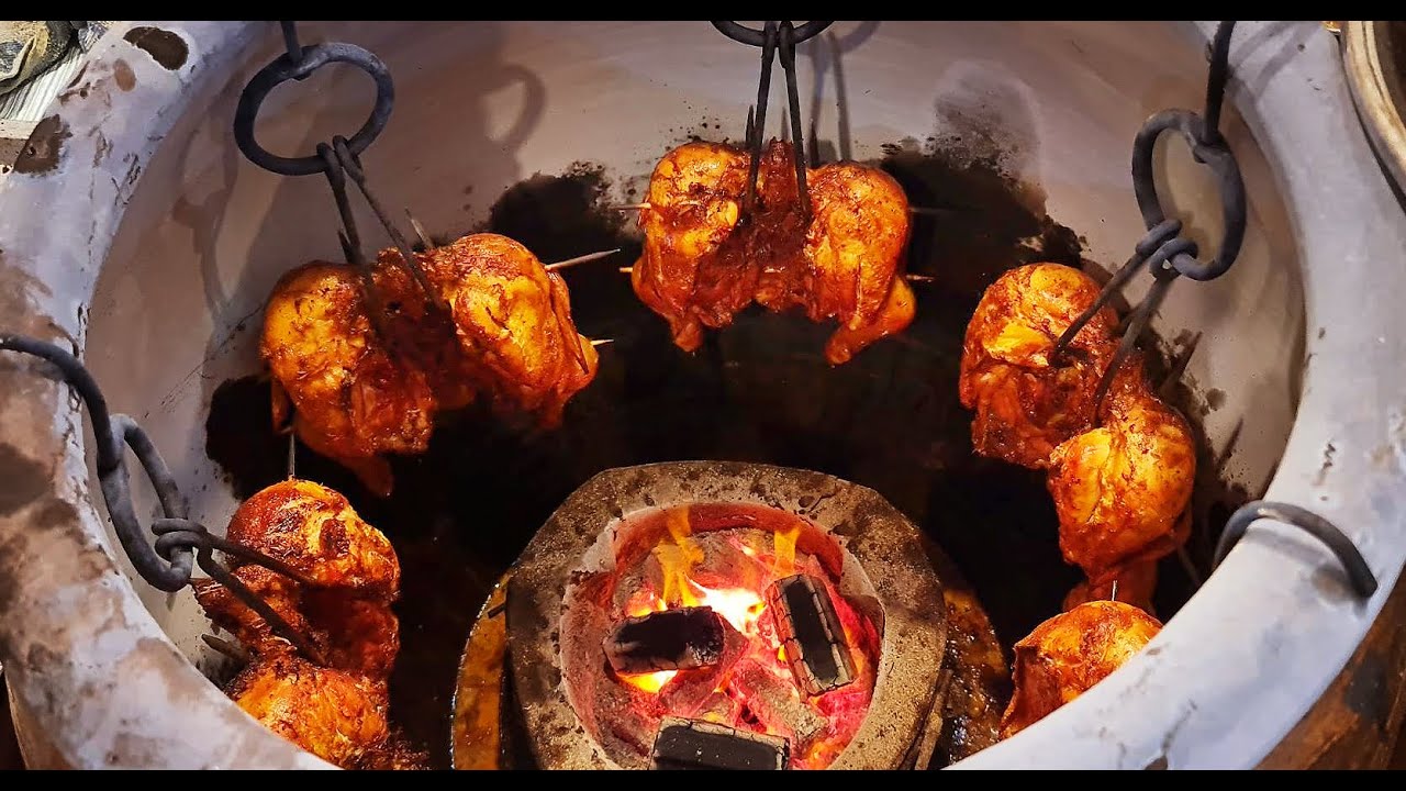 Roasted chicken in charcoal oven / Grilled Full Chicken/ Thailand