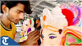 A Rajasthani artist gives finishing touches to eco-friendly idols of Lord Ganesha at Zirakpur