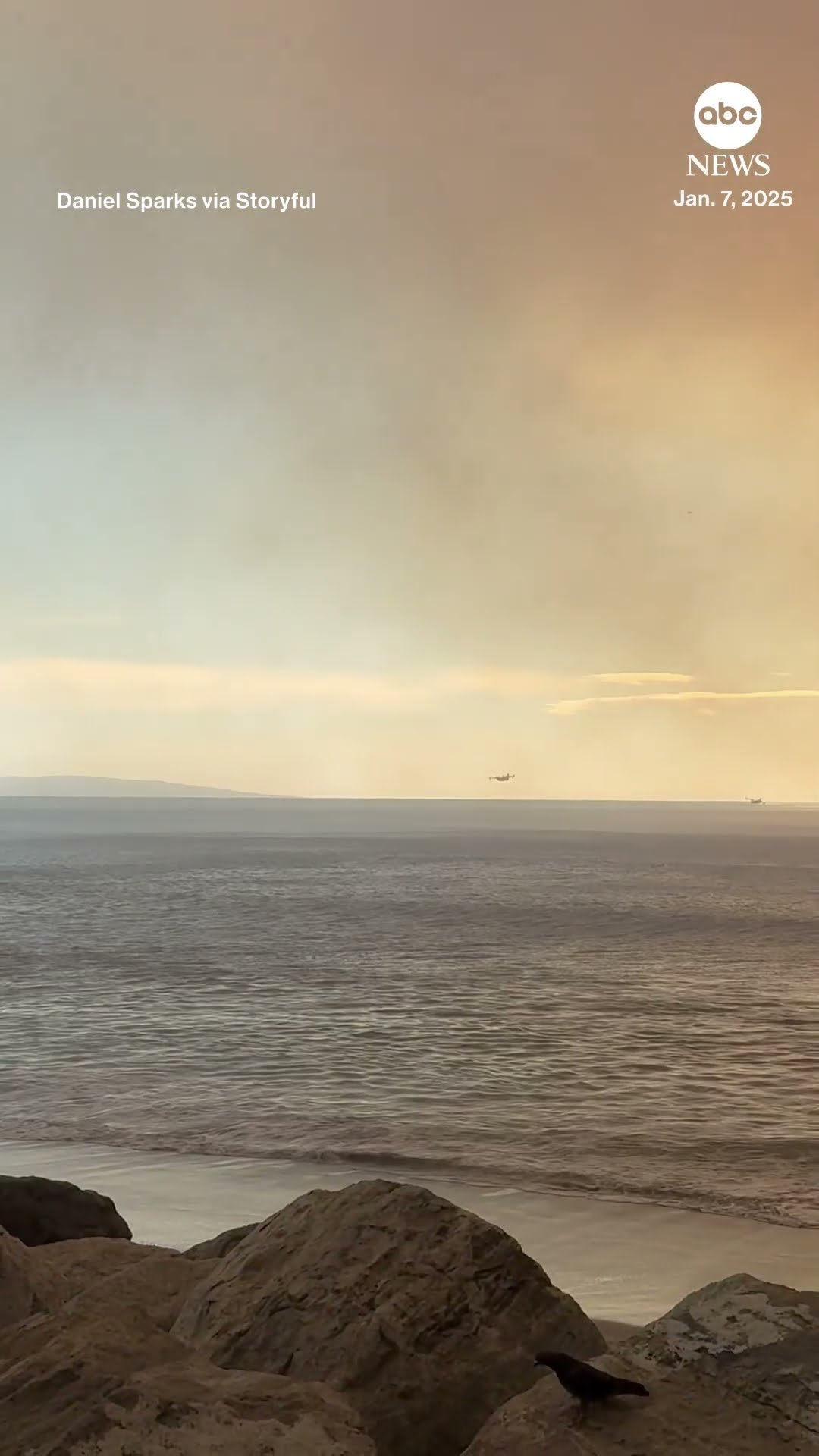 Firefighting planes scoop water as wildfires burn in Los Angeles County