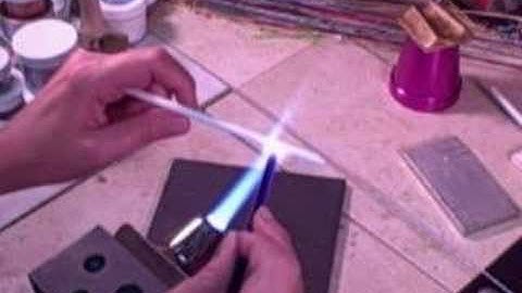 Making encased stringer for glass beads.