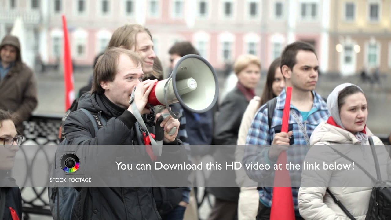 Young man shouting with a megaphone at the protest manifestation