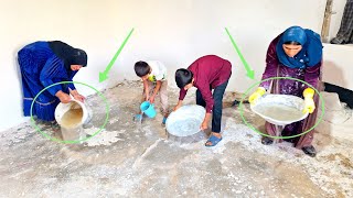 Family and common effort: finishing the white plaster of the wall and washing the house