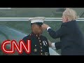 Trump lends hand to Marine whose hat blew away