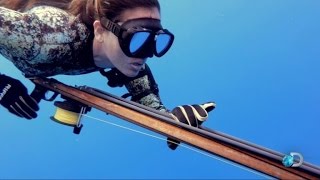 Fearless Fisherwoman Swims at Sharks While Hunting Her Prey Underwater