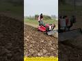 Rural Cool Style: Stylish Girl Driving a Red Tracked Tractor Plowing Fields