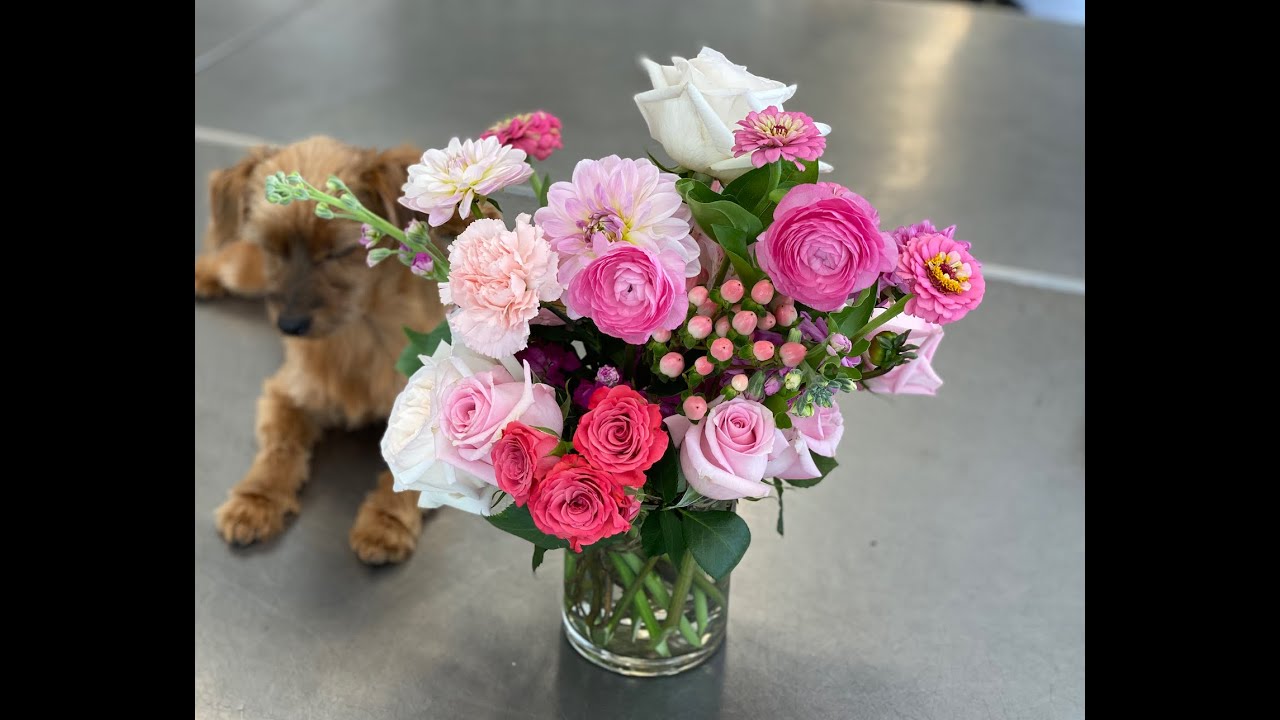 Making an all pink flower arrangement in a vase