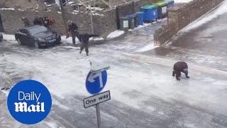 People vs ice: Everyone keep slipping on this icy road in England