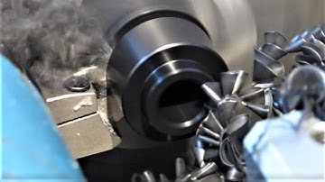 Turning Delrin in small cnc lathe, drilled then profiled with a parting tool. With code improvements