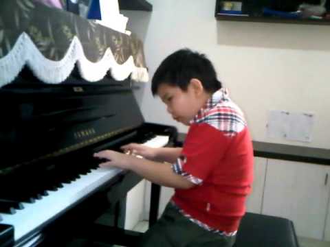 Jason Matthew Utomo (8years old) plays maracas by GLenn R  hunter