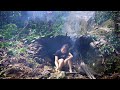 Solo camping in heavy rain build a primitive shelter using rocks and banana leaves
