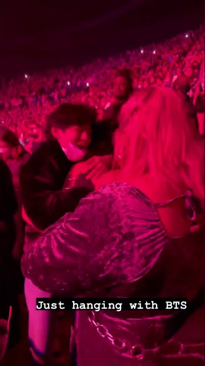 Taehyung hugging a girl at Harry Styles Concert
