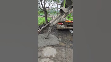 Concrete mixer at work on country road