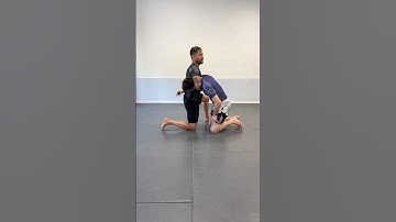 Arm-in guillotine details from the downed front headlock position.