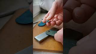 How to punch a snap button by hand with some leathercraft tool and some elbow grease.