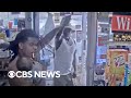 Father holding baby fends off man with gun at Detroit gas station