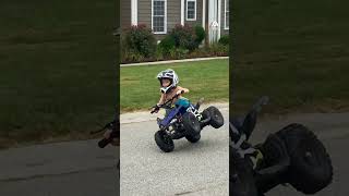 Kid Drives Quad Bike While Balancing on Two Wheels