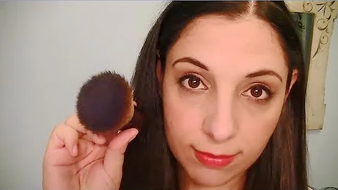 Brushing Your Face And Ears With A Makeup Brush As...