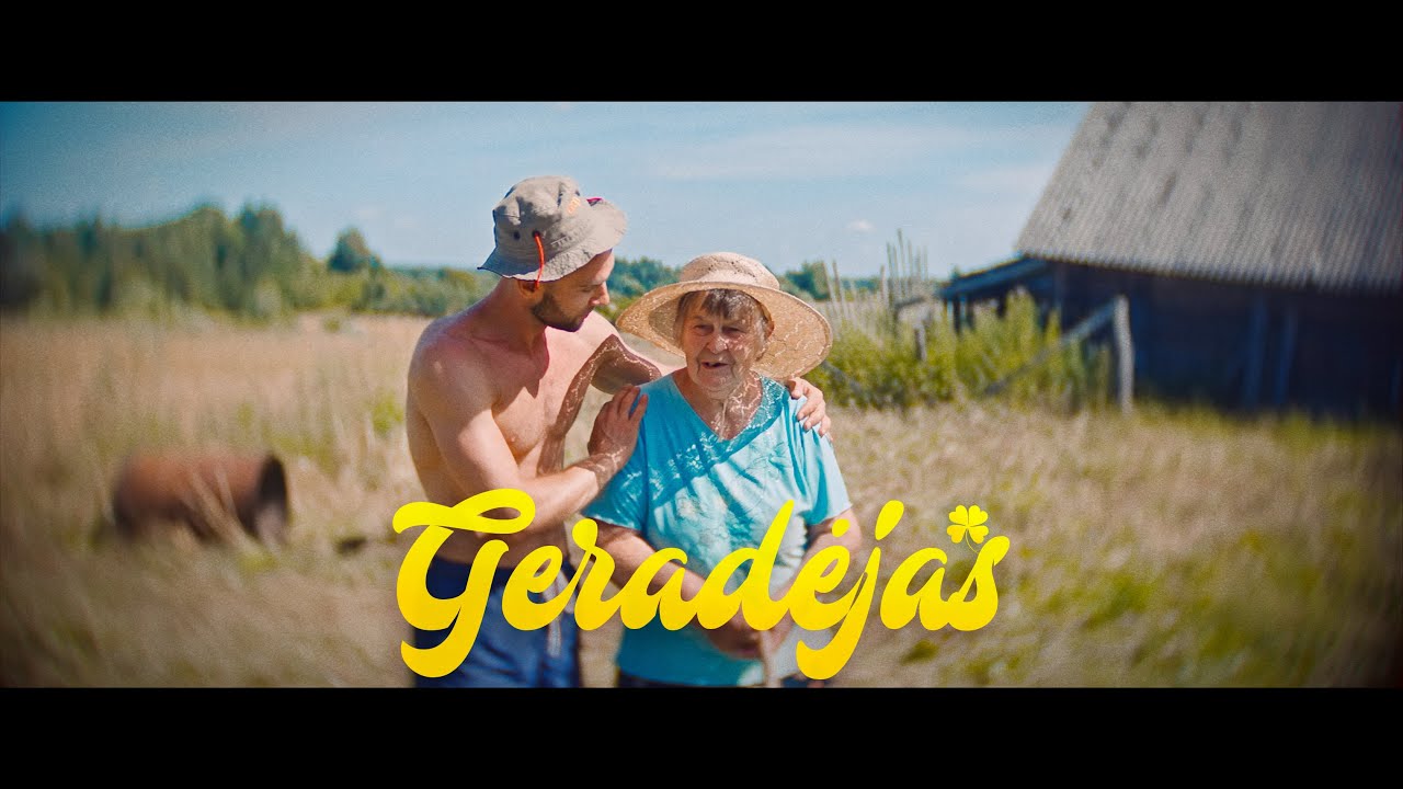 Marytė smiling outdoors with a visitor in a frame from the Geradėjas film