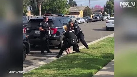 Police officers stop fellow officer punching handcuffed woman during arrest - DayDayNews