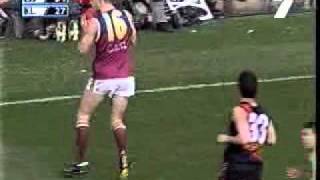 Brad scott takes possession and runs away from james hird during the
2001 afl grand final.