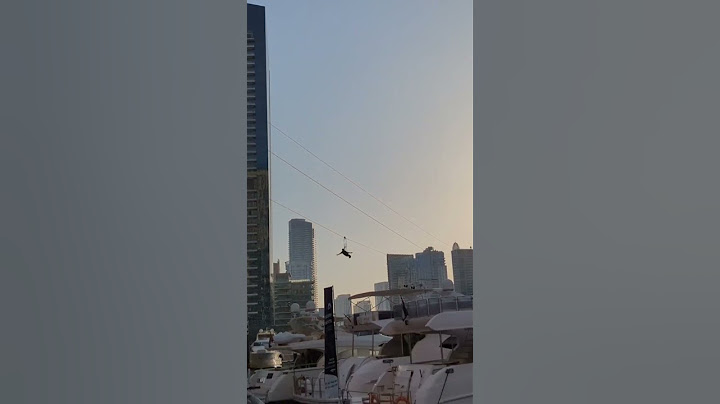 Flying people in Dubai Marina. Zipline.