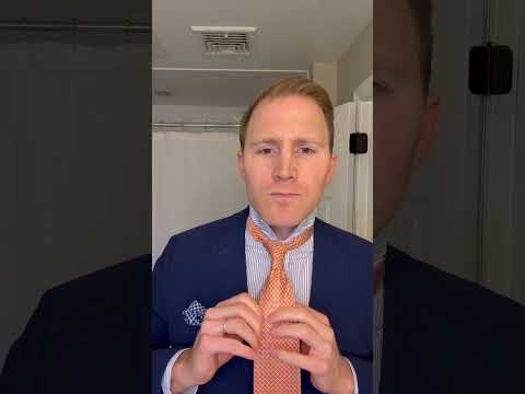 Blue suit and orange tie with striped shirt. Simple knot. GRWM