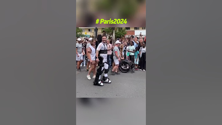 French Paralympian Kevin Piette, paraplegic since 11, carries the Olympic flame in a robotic exosuit