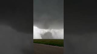 Person Capturing a Forming Tornado on Camera in a Thrilling Storm Chase