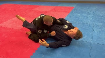 Grip break to overhook collar grip to rolling armbar from guard.