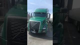 Beautiful green VNL 860 Volvo big rig two window in sleeper visor thin lights single bumper cut out