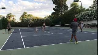 Guys play kickball on tennis court and ball hits boy on his face