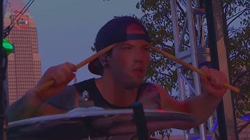 Josh Dun pressing his drum sticks on his head in Guns For Hands.