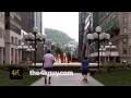 4k u city center water fountain with lamposts buildings and mountain
