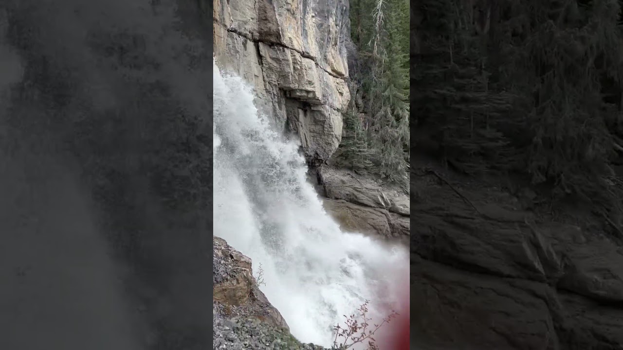 Standing right next to a very powerful waterfall!