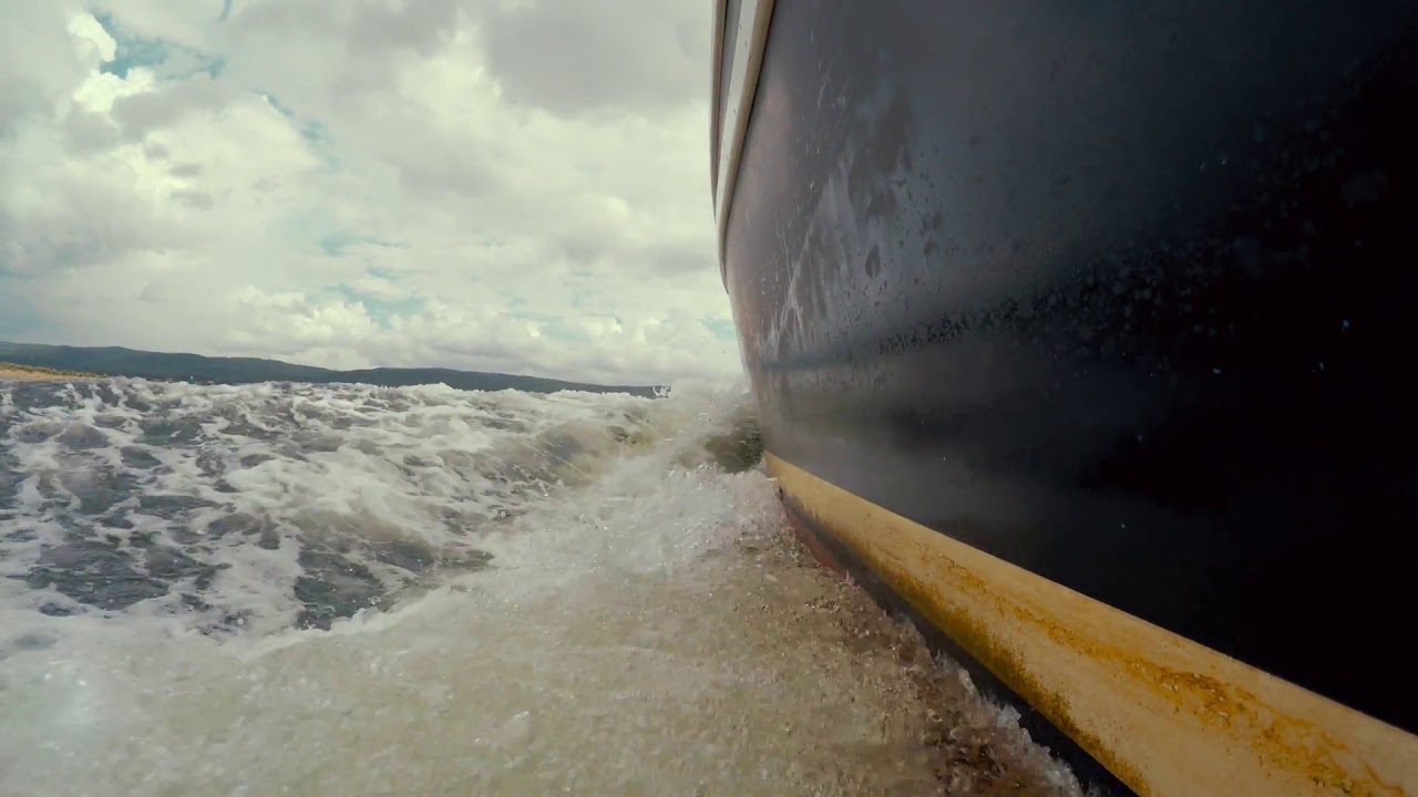 a large wake behind a fishing boat on ocean YouTube