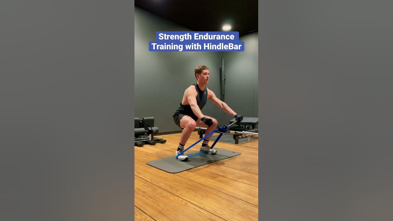 exercise using YouTube Strength raise endurance - hold HindleBar & a training shoulder band for squat loop