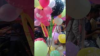 The toy seller is selling balloons made like apples by inflating them toys balloons balloon_show