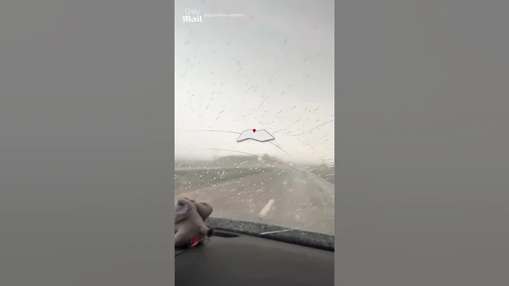 Huge hailstones plummet onto car windshield