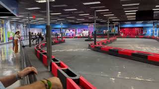 Girl rides Go Kart around track then crashes into falls causing her to fall forward