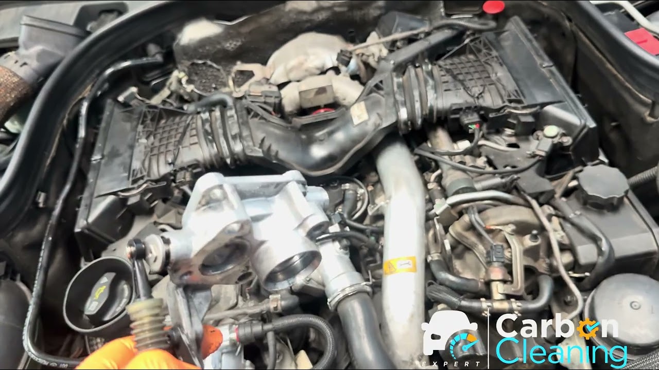 Mercedes E350 with the intake parts off, carbon being cleaned by hand at the Kings Park workshop