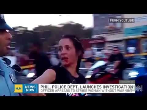 POLICE BRUTALITY - Philadelphia Cop Sucker Punches Woman In The Face During Parade