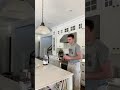 Guy uses his sock to wipe up juice spill.