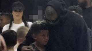 Kanye West comforting Saint west while Kim Kardashian watch in a distance