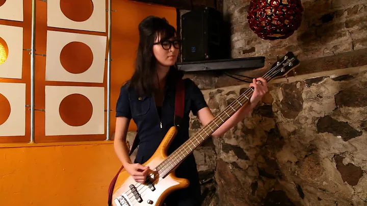 Julia Clements on Bass wearing Blake Kuwahara