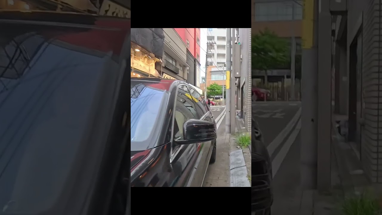 A dangerous black car obstructing pedestrians