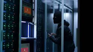 A man with face mask hacking a data centre | Hacking Stock Footage | Hacker Clip