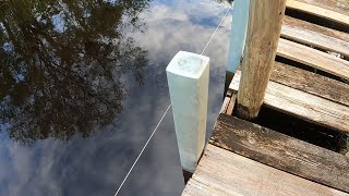 Water jetting a dock post. Content