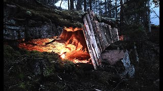 Survival log shelter under a cliff  - Solo Bushcraft