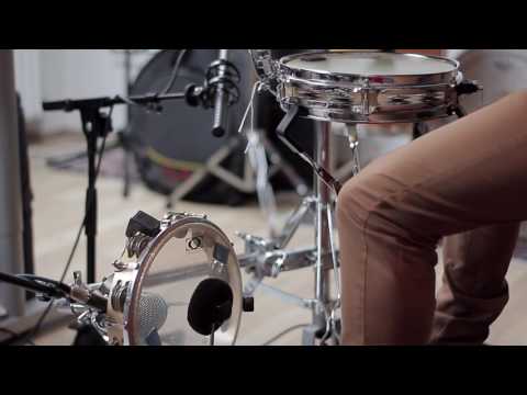 A pandeiro mounted as a bass drum with a microphone placed on the head