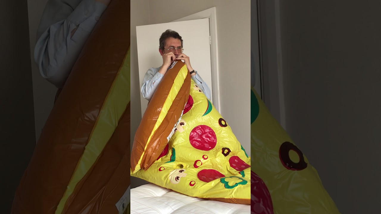 Lung power challenge blowing up a giant pizza slice pool float using lung power only